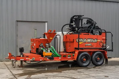 2015 Ditch Witch MR90 mud recycler, 3/4 view, tandem-axle trailer, mixing hopper, pump, green suction hoses, fluid tank visible