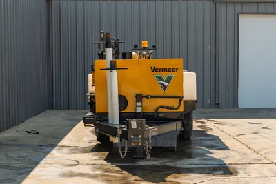 2024 Vermeer LP573SGT vacuum excavator, rear view, trailer-mounted with suction boom, engine enclosure, and fluid tanks.