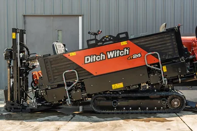 Side profile of 2020 Ditch Witch JT24 HDD drill showing engine compartment, operator station, drill rack, and rubber tracks.