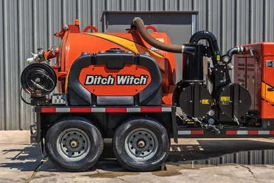 2023 Ditch Witch HX30 mud mixing system, trailer-mounted, side view showing water tank, hose reel, pump assembly, and tandem axle