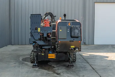2021 Ditch Witch JT28 HDD drill, front view, showing spindle, hydraulic hoses, drill frame, rubber tracks, and engine compartment with Ditch Witch logo