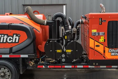 2023 Ditch Witch HX75 mud recycler pump assembly, close-up of black centrifugal pump unit with hoses, gauges, and manifold plumbing visible