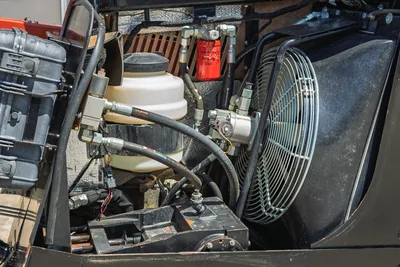 Open engine compartment of 2021 Ditch Witch JT20 showing hydraulic cooling fan, reservoir, and filter assembly.