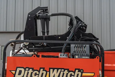 2015 Ditch Witch MR90 mud recycler control panel, hydraulic manifold, toggle switches, and routed hoses, close-up rear angle.