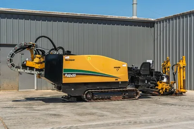 2019 Vermeer D40x55 S3 HDD drill, side view, yellow body, rubber tracks, drill frame, hydraulic hoses, operator seat, pipe rack visible