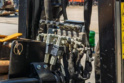 2021 Ditch Witch JT20 hydraulic control valve bank, showing manual levers, fittings, and hoses in close-up detail.