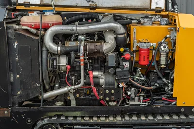 2018 Vermeer D8x12 HDD engine compartment open, showing Kohler 48hp engine, turbo, alternator, hydraulic filters, and red battery cables.