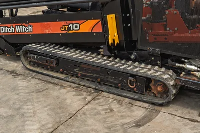 Side profile of 2018 Ditch Witch JT10 horizontal directional drill showing rubber track undercarriage and engine compartment.