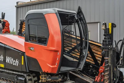 2021 Ditch Witch AT40 All Terrain operator cab, open door, drill pipe rack, and track assembly side view.