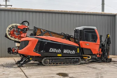 2021 Ditch Witch AT40 All Terrain directional drill, side view, steel tracks, enclosed cab, and drill pipe rack.