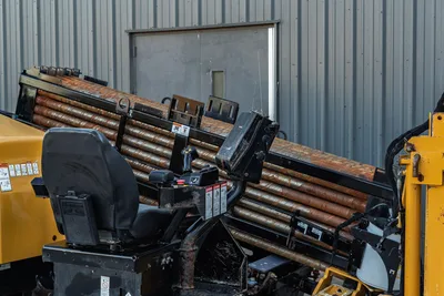 2019 Vermeer D40x55 S3 drill pipe rack loaded with 2.625" HDD pipe, operator seat and joystick controls visible
