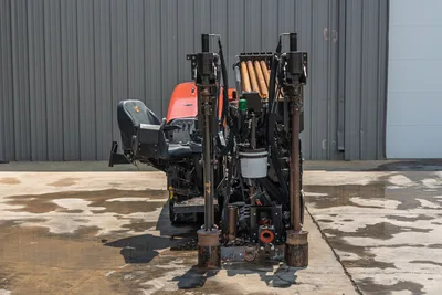 2023 Ditch Witch JT20 rear view showing drill frame, pipe rack with loaded drill pipe, anchor assemblies, and operator seat