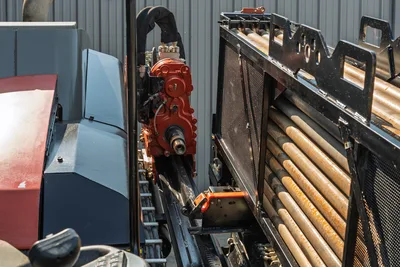 2020 Ditch Witch JT24 carriage, rack-and-pinion drill frame, and drill pipe magazine in a high-angle side profile view.