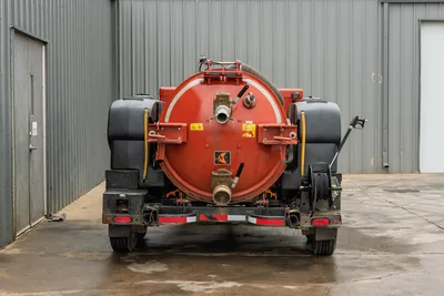 2023 Ditch Witch HX75 mud recycler, rear view, red vacuum tank, dual poly water tanks, hose reel, discharge ports, trailer axle