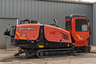 2016 Ditch Witch JT25 HDD rig, driver-side view, orange hood with branding, enclosed cab, rubber tracks, hydraulic lines visible