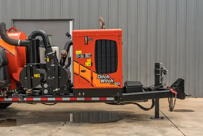 2023 Ditch Witch HX50 mud recycler, side view on trailer, engine compartment, pump assembly, hoses, jack stands, and tow hitch visible