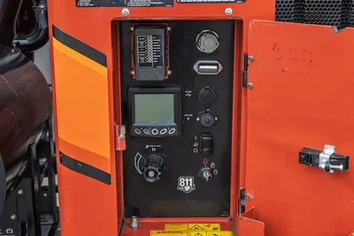Ditch Witch HX75 mud recycler control panel showing LCD display, fuse block, throttle knob, USB/12V ports, and 811 decal