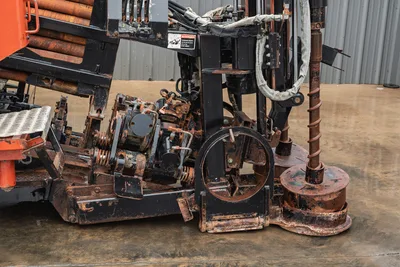 Ditch Witch JT4020 MACH 1 drill string, rotation head, pipe loader, and hydraulic carriage assembly in worn condition.