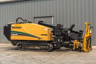 2014 Vermeer D24x40 Series II HDD drill featuring yellow housing, operator seat, drill pipe rack, and tracks in profile view.