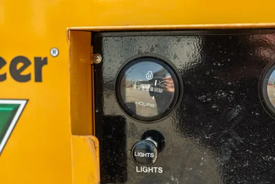 Vermeer LP573SGT hour meter showing 199 operating hours on black control panel with lights switch.