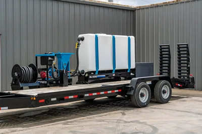 Behnke CBCT2324E-BT-R mud mixing trailer with SL500 tank, PM170 mixer, hose reel, tandem axle, and beaver tail ramps, 3/4 view