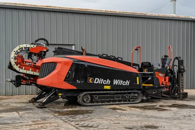 2021 Ditch Witch JT40 HDD drill, driver-side view, rubber tracks, pipe carousel, drill frame, operator station, orange/black livery