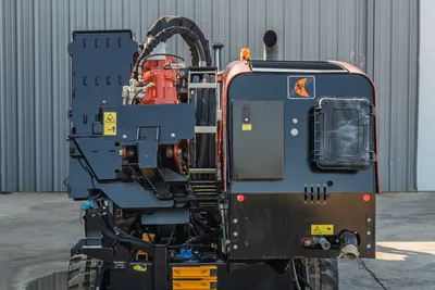 2021 Ditch Witch JT28 rear view showing drill drive rotary head, hydraulic hoses, control panel, Ditch Witch logo, and strobe light