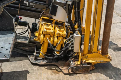 2021 Vermeer D24x40 S3 HDD drill head carriage, yellow spindle drive motors, hydraulic hoses, and drill pipe on thrust frame