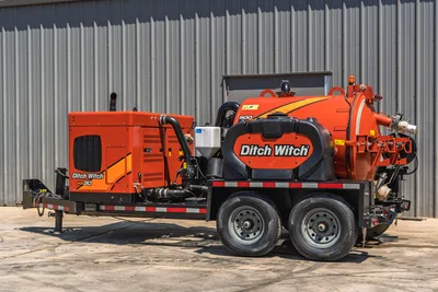 2023 Ditch Witch HX30 mud recycler, rear 3/4 view on tandem-axle trailer, orange tank, engine enclosure, vacuum hose inlet visible