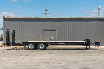 2026 Behnke FB8X30SDPT-40L flatbed trailer, full side profile, black steel deck, tandem axles, pipe rack, gooseneck hitch