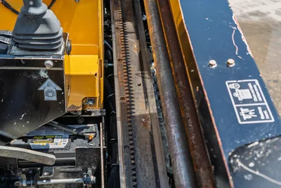 2021 Vermeer D8x12 drill frame close-up showing rack-and-pinion thrust mechanism, drill pipe, joystick control, and battery compartment