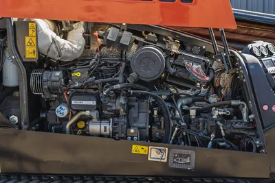 Engine compartment view of 2023 Ditch Witch JT20 showing fuel system, wiring harnesses, air intake, and hydraulic components.