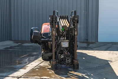 Rear view of 2023 Ditch Witch JT20 HDD drill featuring pipe rack, hydraulic stabilizers, operator station, and track drive.