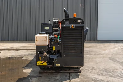 2018 Ditch Witch JT10 rear view showing engine compartment, hydraulic fluid tank, control levers, and amber strobe light.