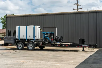 Behnke CBCT2324E-BT-R HDD mud mixing trailer with white poly tank, SL500 mixer, PM170 pump, hose reel, tandem axle, side profile view