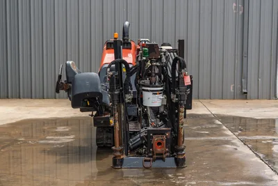 Rear view of 2018 Ditch Witch JT10 HDD drill showing operator seat, drill pipe box, hydraulic hoses, and track assembly.