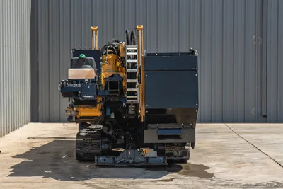 2020 Vermeer D24x40 S3 HDD drill, rear view, rubber tracks, drill frame, hydraulic hoses, vise, fluid tank, yellow and black finish
