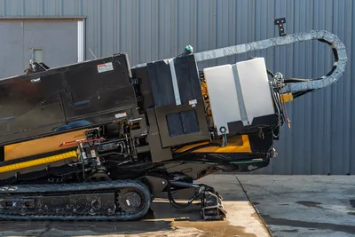 2016 Vermeer D23x30 S3 HDD drill rear-side view showing drill frame angled up, cable carrier, fluid tank, hydraulic lines, and rubber tracks