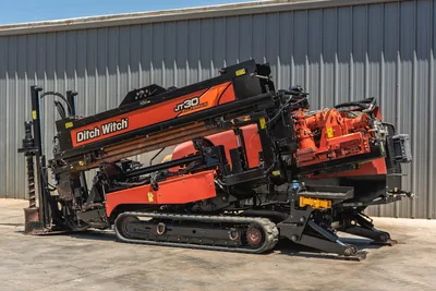 2018 Ditch Witch JT30 All Terrain HDD drill, driver-side angle, drill pipe loaded on carriage, rubber tracks, hydraulic spindle visible
