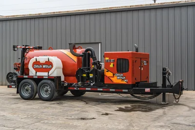 2019 Ditch Witch HX30 vacuum excavator, side profile, showing spoil tank, water tank, engine housing, and tandem axle.