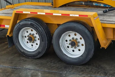 2021 TowMaster T-20D tandem axle closeup, dual 235/75R17.5 MasterTrack M-TRAC tires, white steel wheels, yellow frame with reflectors