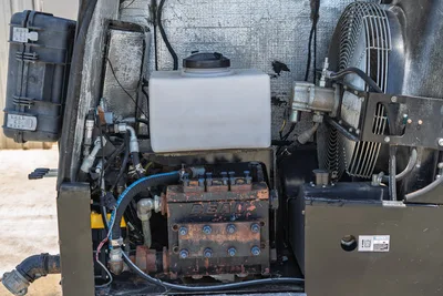 2018 Ditch Witch JT30 All Terrain engine compartment showing Bean mud pump, coolant reservoir, cooling fan, and hydraulic lines