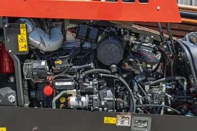 2021 Ditch Witch JT20 engine compartment view showing well-maintained diesel motor, hydraulic components, and wiring harness.