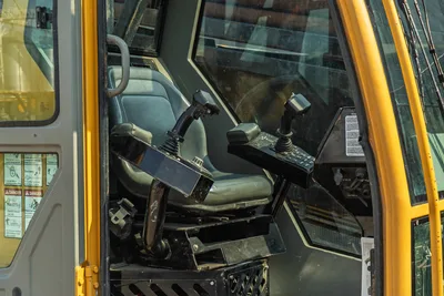 2017 Vermeer D100x140 S3 cab interior showing operator seat, dual joystick controls, and safety decals via open door