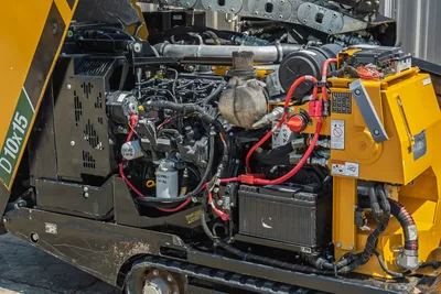 Vermeer 10x15 S3 engine compartment detail showing 60 hp diesel engine, radiator, hydraulic lines, control panel, and powerhead assembly