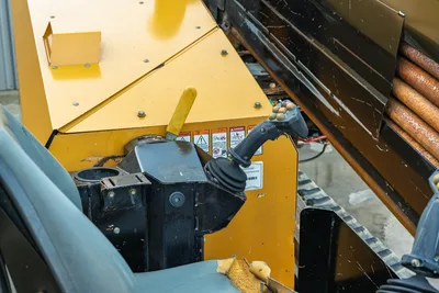 2021 Vermeer D23x30 S3 operator console closeup showing joystick controls, warning decals, drill pipe rack with used pipe
