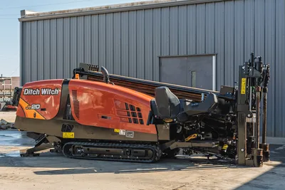 2023 Ditch Witch JT20 horizontal directional drill, side profile view showing tracks, engine housing, and pipe rack.