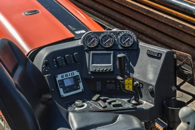 2018 Ditch Witch JT20 operator station view: gauges, controls, ESID display, joystick, and stacked drill pipe.