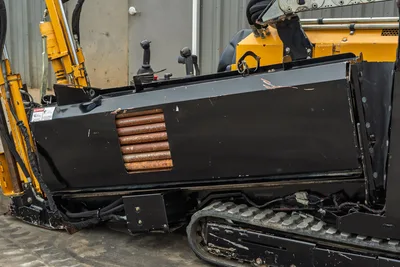 2018 Vermeer D8x12 HDD drill, side view showing black engine enclosure with rusted cooling fins, rubber tracks, drill mast, and operator controls