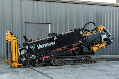 2019 Vermeer D40x55 S3 HDD drill angled upward, showing tracks, drill pipe carriage, hydraulic hoses, and engine compartment